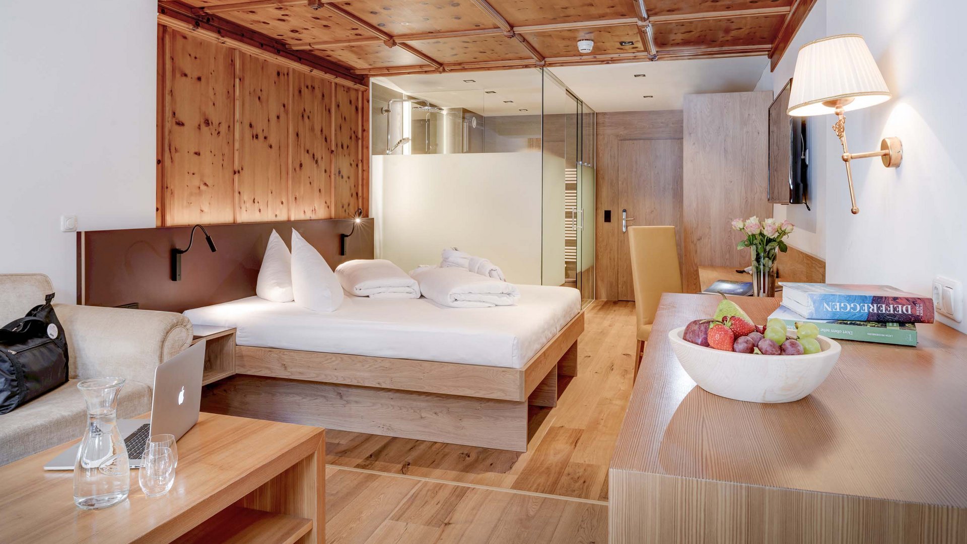 Our family hotel in Tyrol with a 4-star superior rating Modern hotel room with wooden furniture and cozy double bed