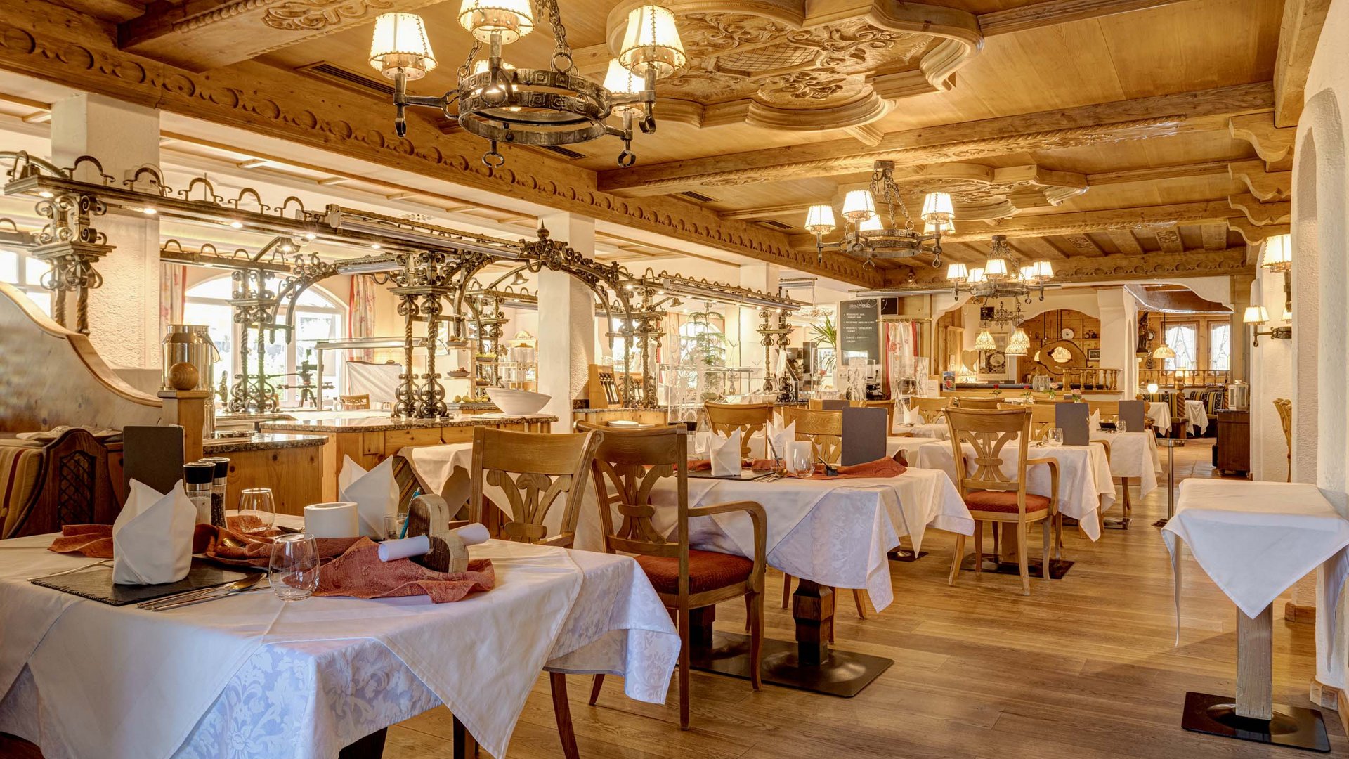 Jesacherhof: Gourmethotel in Österreich Elegantes Restaurant mit traditionellem Holzdekor und gedeckten Tischen